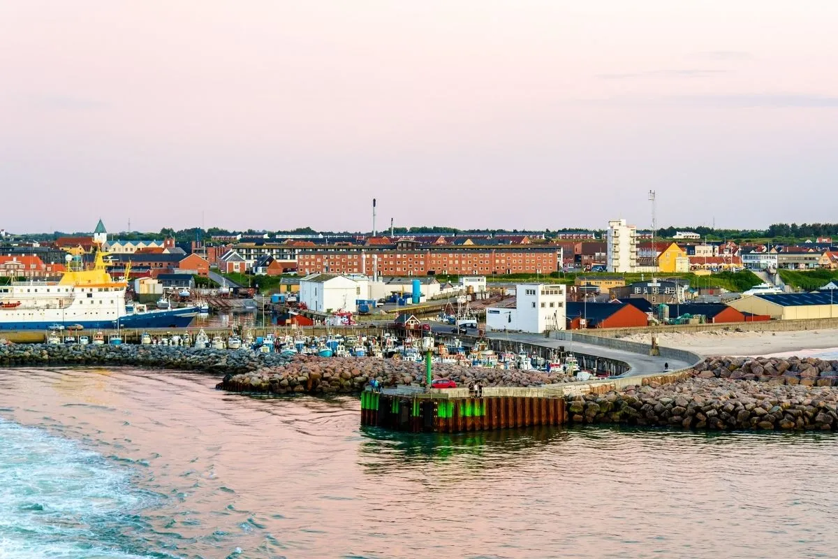 Hirtshals harbour seen from the water, with the breakwater and fishing fleet in the foreground