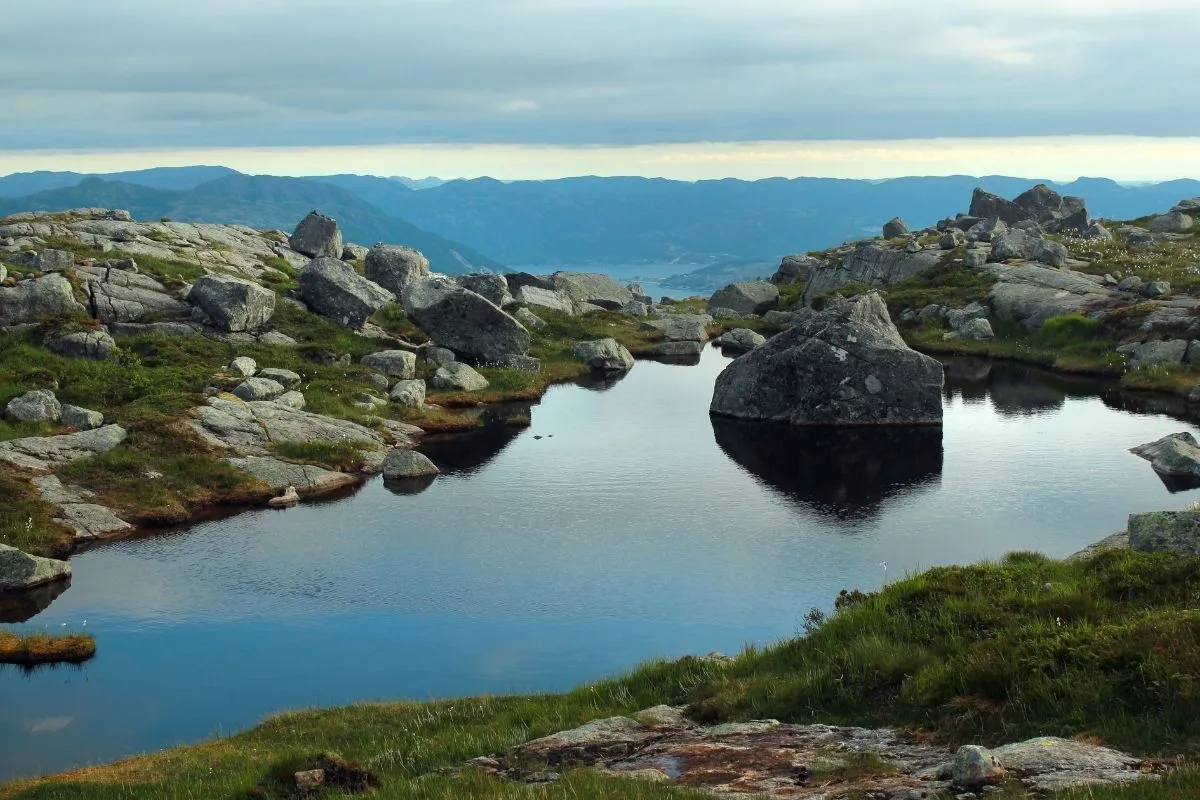A mountain lake in Rogaland, with boulders and a ridge line behind